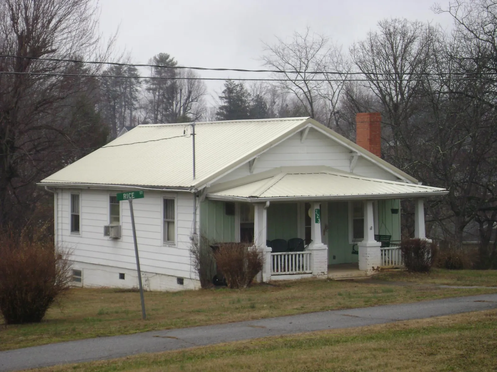 White metal roof on a craftsman bungalow at a street corner in East Dennis